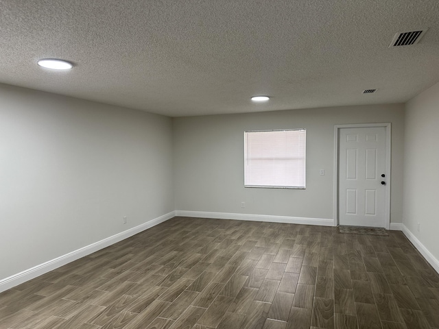 496 E Jordan Blvd, Pahokee, FL 33476 - unfurnished room featuring dark wood finished floors, a textured ceiling, baseboards, and recessed lighting