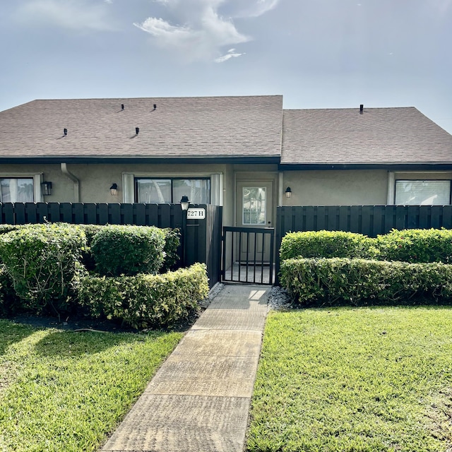 727 Sunny Pine Way Unit H, Greenacres, FL 33415 - view of front facade featuring a gate and stucco siding