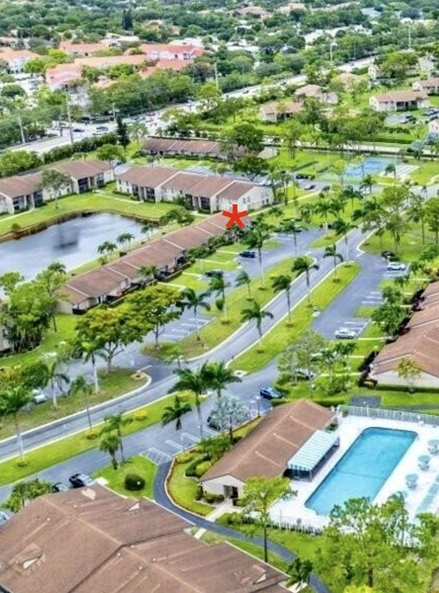 727 Sunny Pine Way Unit H, Greenacres, FL 33415 - bird's eye view of a pool area and a large body of water