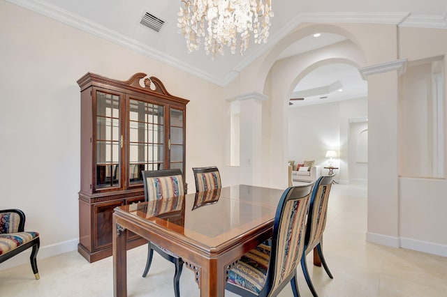 13209 Alhambra Lake Cir, Delray Beach, FL 33446 - dining space featuring arched walkways, decorative columns, ornamental molding, a chandelier, and light tile patterned flooring