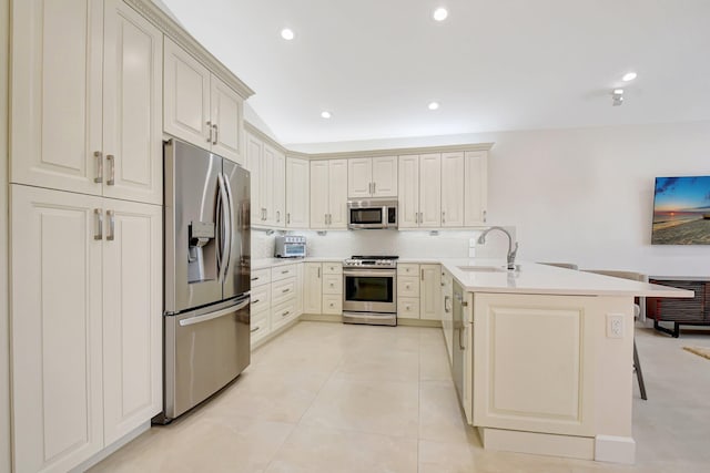 13209 Alhambra Lake Cir, Delray Beach, FL 33446 - kitchen featuring stainless steel appliances, a peninsula, a sink, light countertops, and recessed lighting
