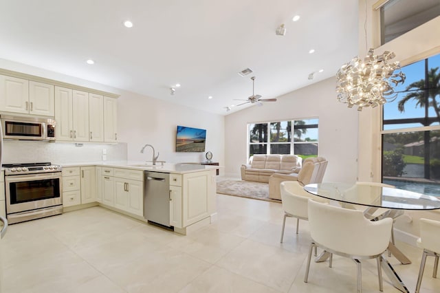 13209 Alhambra Lake Cir, Delray Beach, FL 33446 - kitchen featuring stainless steel appliances, a peninsula, a sink, recessed lighting, and backsplash