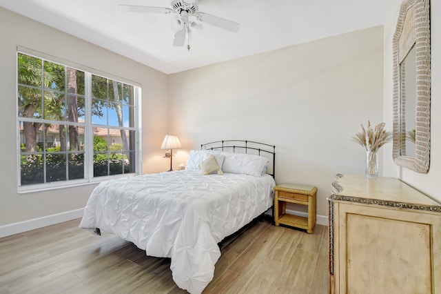 13209 Alhambra Lake Cir, Delray Beach, FL 33446 - bedroom featuring baseboards, light wood-type flooring, and a ceiling fan