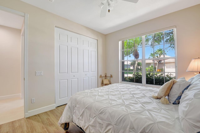 13209 Alhambra Lake Cir, Delray Beach, FL 33446 - bedroom with light wood-style flooring, a closet, ceiling fan, and baseboards