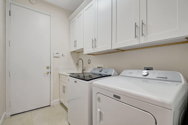 13209 Alhambra Lake Cir, Delray Beach, FL 33446 - laundry room with separate washer and dryer, baseboards, cabinet space, and light tile patterned floors