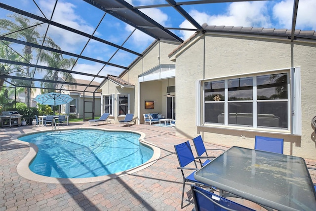 13209 Alhambra Lake Cir, Delray Beach, FL 33446 - outdoor pool with outdoor dining area, a patio area, grilling area, and glass enclosure