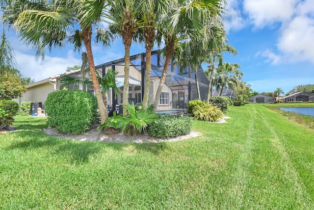 13209 Alhambra Lake Cir, Delray Beach, FL 33446 - view of grassy yard with a lanai and a water view