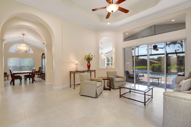 13209 Alhambra Lake Cir, Delray Beach, FL 33446 - living area featuring a chandelier, arched walkways, ceiling fan, plenty of natural light, and vaulted ceiling