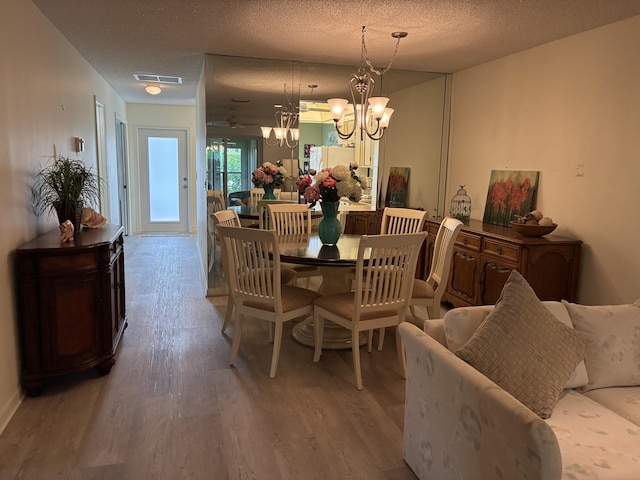 5178 Privet Pl Unit D, Delray Beach, FL 33484 - dining room featuring a chandelier, wood finished floors, and a textured ceiling