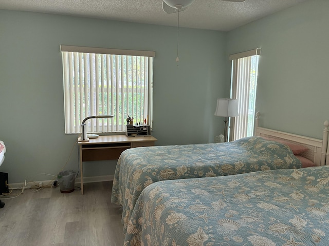 5178 Privet Pl Unit D, Delray Beach, FL 33484 - bedroom with wood finished floors, baseboards, and a textured ceiling