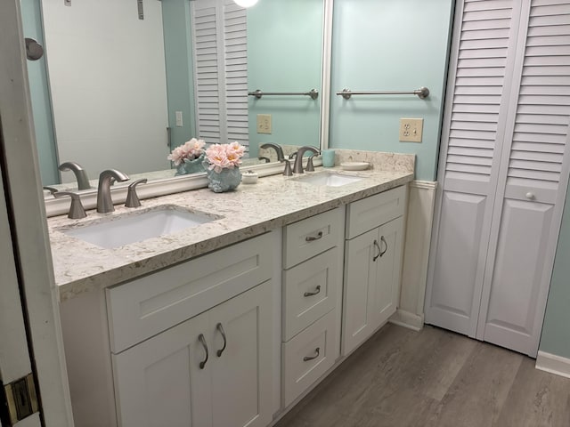 5178 Privet Pl Unit D, Delray Beach, FL 33484 - bathroom featuring a closet, double vanity, wood finished floors, and baseboards