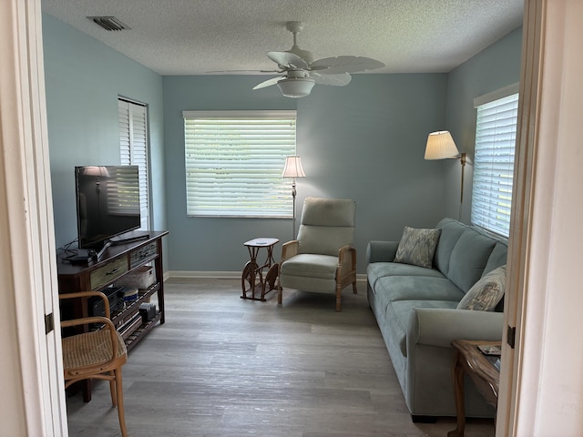 5178 Privet Pl Unit D, Delray Beach, FL 33484 - living room featuring wood finished floors, baseboards, a ceiling fan, and a textured ceiling