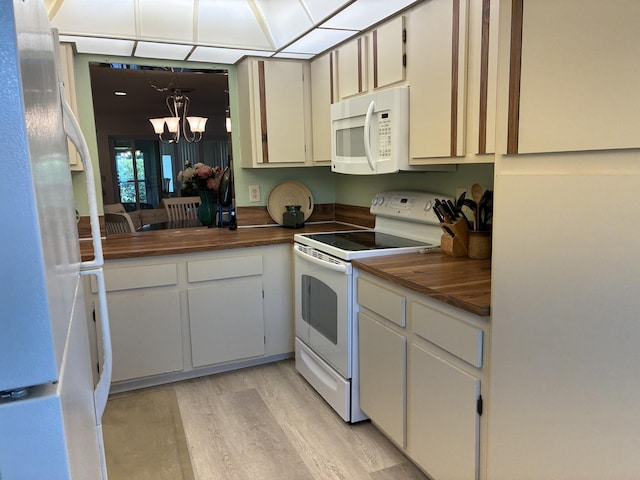 5178 Privet Pl Unit D, Delray Beach, FL 33484 - kitchen with white appliances, wood counters, a chandelier, and light wood-style floors