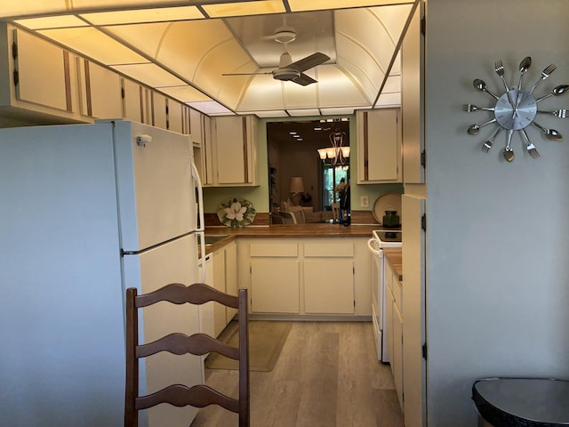 5178 Privet Pl Unit D, Delray Beach, FL 33484 - kitchen with white appliances, a chandelier, dark countertops, light wood finished floors, and a ceiling fan