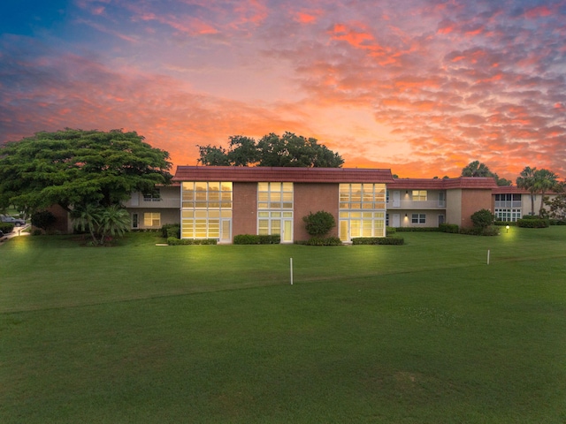 8 Vista Palm Ln Unit 103, Vero Beach, FL 32962 - view of front of property featuring a lawn and stucco siding