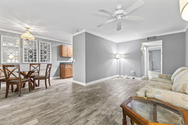 8 Vista Palm Ln Unit 103, Vero Beach, FL 32962 - living area with ornamental molding, light wood-style flooring, baseboards, and a ceiling fan