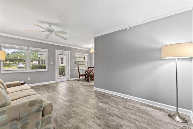 8 Vista Palm Ln Unit 103, Vero Beach, FL 32962 - unfurnished living room with ornamental molding, baseboards, ceiling fan, and wood finished floors