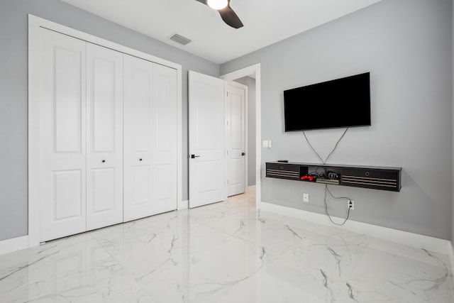 2265 SW Kenwick Ave, Port Saint Lucie, FL 34953 - unfurnished bedroom with marble finish floors, a closet, and a ceiling fan