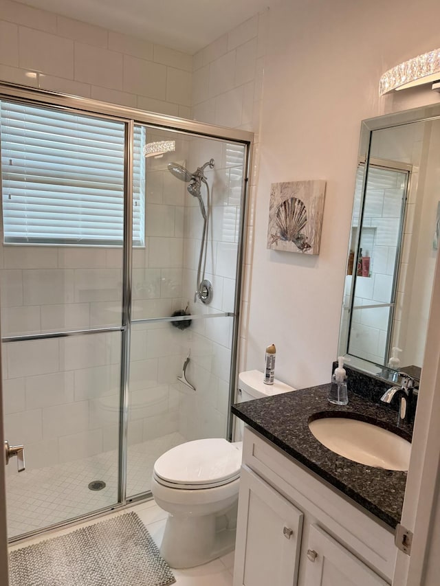 10876 SW Sunray St, Port Saint Lucie, FL 34987 - full bath with a stall shower, vanity, toilet, and tile patterned flooring