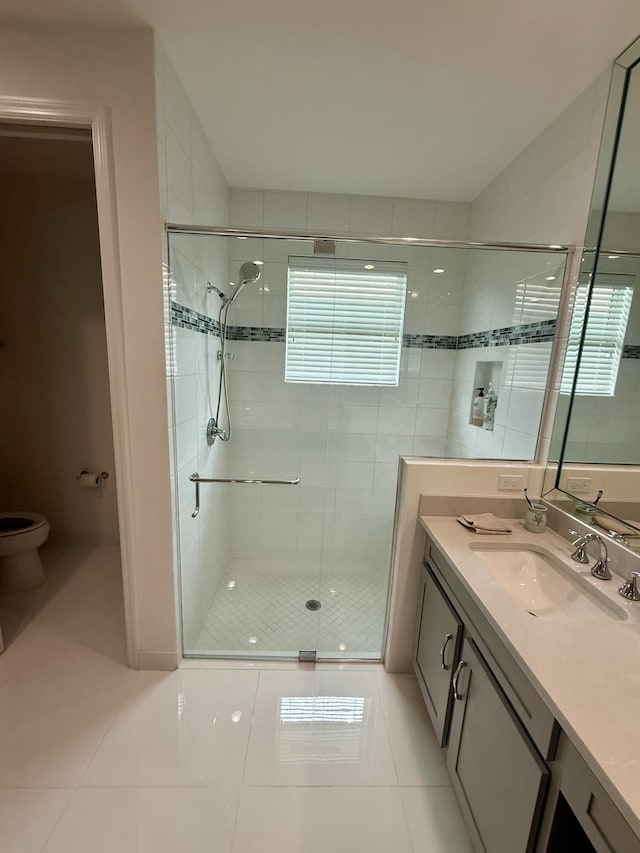 10876 SW Sunray St, Port Saint Lucie, FL 34987 - full bathroom featuring tile patterned flooring, toilet, a shower stall, and vanity
