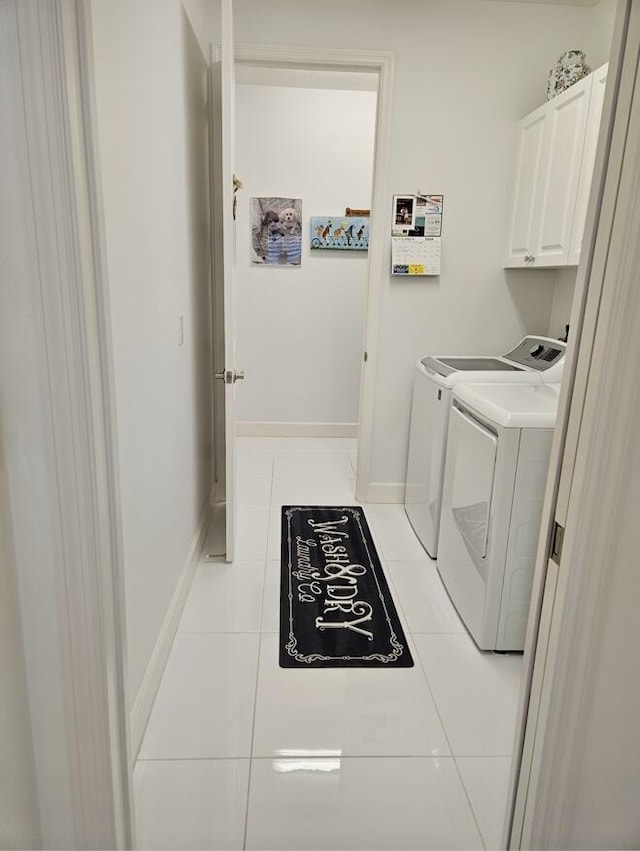 10876 SW Sunray St, Port Saint Lucie, FL 34987 - washroom with cabinet space, tile patterned flooring, washer and dryer, and baseboards