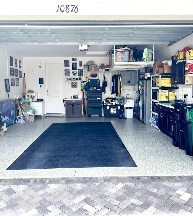 10876 SW Sunray St, Port Saint Lucie, FL 34987 - garage with freestanding refrigerator and a garage door opener