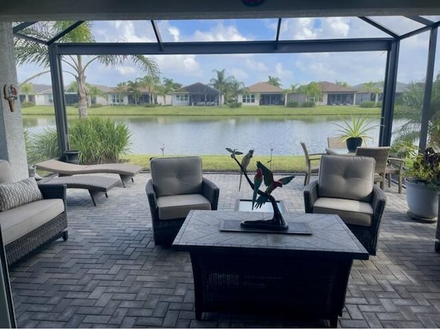 10876 SW Sunray St, Port Saint Lucie, FL 34987 - view of patio with an outdoor living space, glass enclosure, and a water view