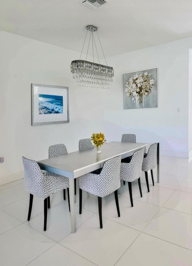10876 SW Sunray St, Port Saint Lucie, FL 34987 - tiled dining space featuring baseboards and a chandelier