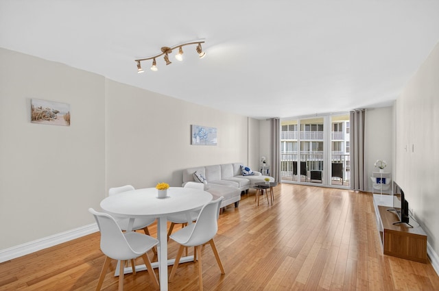 3540 S Ocean Blvd Unit 610, South Palm Beach, FL 33480 - dining area featuring light wood finished floors, baseboards, and floor to ceiling windows