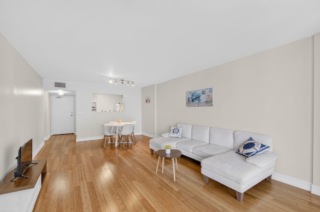 3540 S Ocean Blvd Unit 610, South Palm Beach, FL 33480 - living room with light wood-style floors, baseboards, and rail lighting