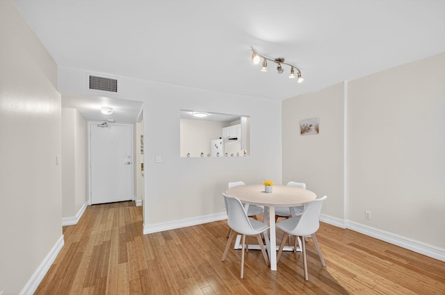 3540 S Ocean Blvd Unit 610, South Palm Beach, FL 33480 - dining area featuring light wood-style flooring and baseboards