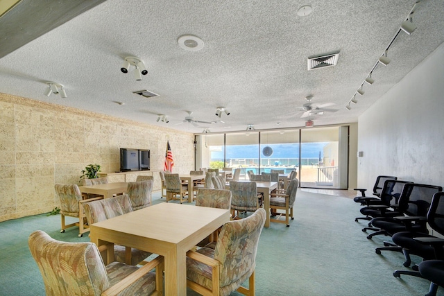 3540 S Ocean Blvd Unit 610, South Palm Beach, FL 33480 - dining room featuring track lighting, carpet floors, floor to ceiling windows, a ceiling fan, and a textured ceiling