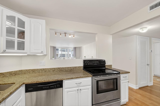 3540 S Ocean Blvd Unit 610, South Palm Beach, FL 33480 - kitchen with stainless steel appliances, light wood-style flooring, white cabinets, and light stone counters