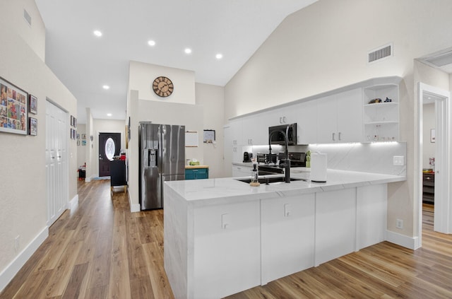 11080 Lakeaire Cir, Boca Raton, FL 33498 - kitchen featuring appliances with stainless steel finishes, a peninsula, a sink, open shelves, and white cabinets