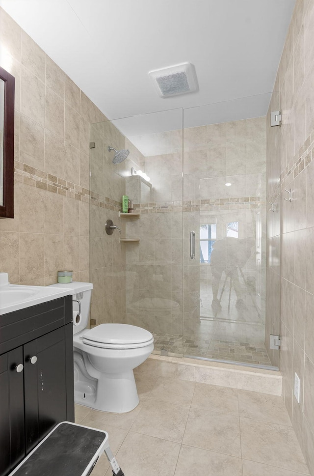 11080 Lakeaire Cir, Boca Raton, FL 33498 - full bathroom with tile walls, vanity, toilet, a stall shower, and tile patterned flooring