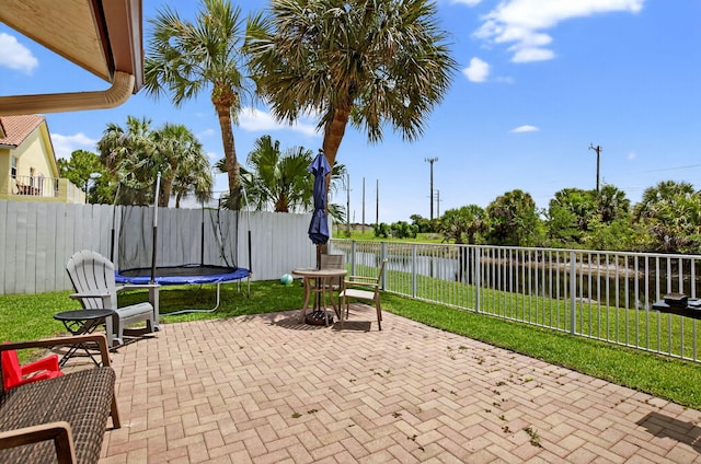 11080 Lakeaire Cir, Boca Raton, FL 33498 - view of patio featuring a trampoline, a water view, and outdoor dining area