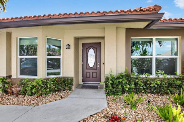 11080 Lakeaire Cir, Boca Raton, FL 33498 - entrance to property featuring a tile roof and stucco siding