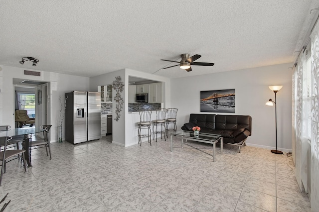 1116 Cambridge E Unit E, Deerfield Beach, FL 33442 - living room with ceiling fan and a textured ceiling
