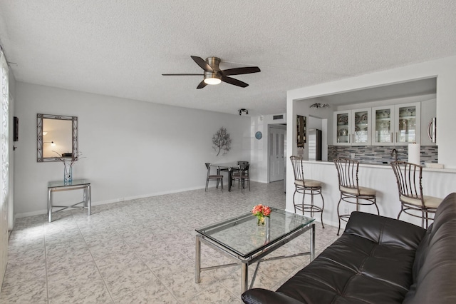 1116 Cambridge E Unit E, Deerfield Beach, FL 33442 - living area featuring a ceiling fan and a textured ceiling