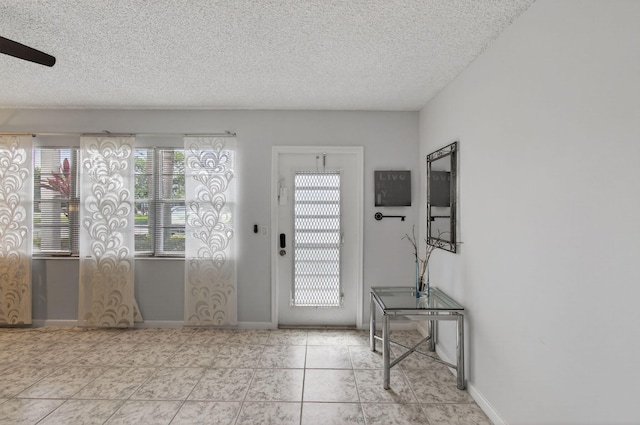 1116 Cambridge E Unit E, Deerfield Beach, FL 33442 - entrance foyer with a textured ceiling, tile patterned floors, and ceiling fan