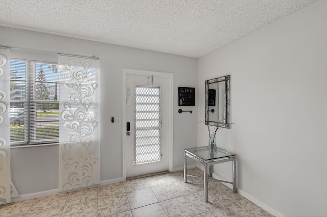 1116 Cambridge E Unit E, Deerfield Beach, FL 33442 - entryway featuring a textured ceiling and tile patterned floors