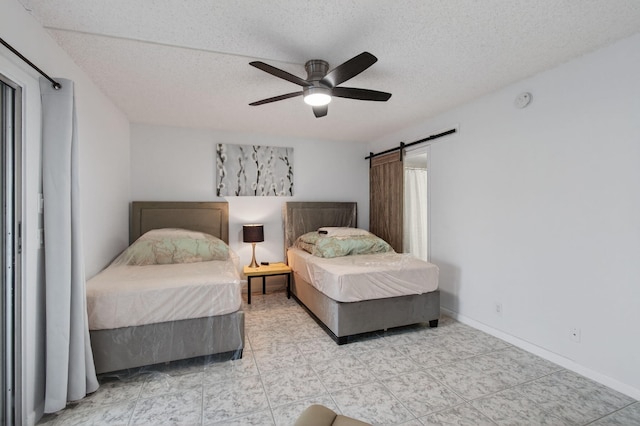 1116 Cambridge E Unit E, Deerfield Beach, FL 33442 - bedroom featuring a barn door, a textured ceiling, and ceiling fan