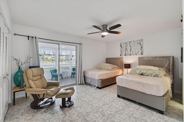 1116 Cambridge E Unit E, Deerfield Beach, FL 33442 - bedroom with access to outside, a textured ceiling, and a ceiling fan