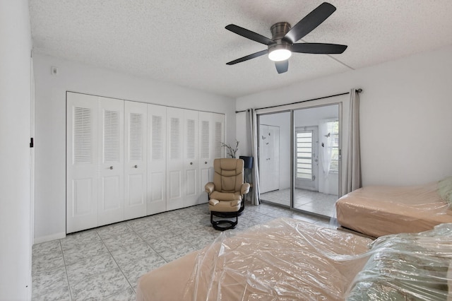 1116 Cambridge E Unit E, Deerfield Beach, FL 33442 - tiled bedroom with a textured ceiling, access to exterior, and a ceiling fan