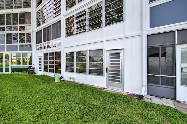 1116 Cambridge E Unit E, Deerfield Beach, FL 33442 - view of property exterior with a lawn