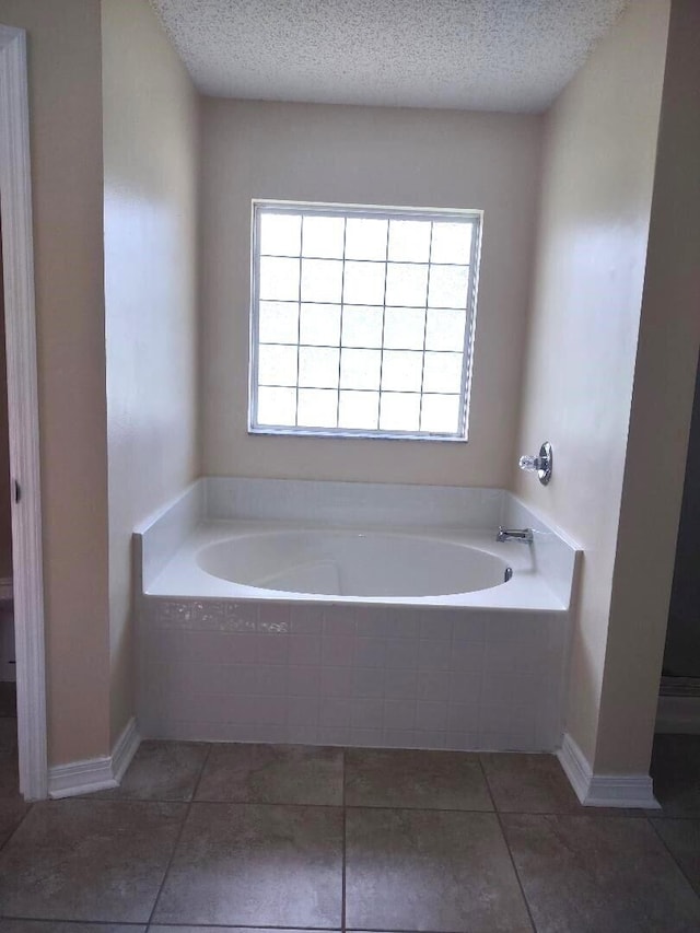 1032 SW Castaneda Ln SW, Port Saint Lucie, FL 34953 - bathroom with a garden tub, a textured ceiling, and tile patterned flooring