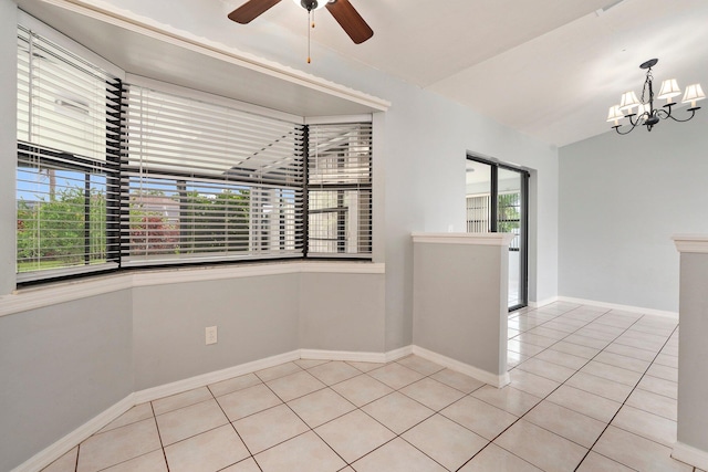2455 SW Datura Ave, Port Saint Lucie, FL 34953 - spare room with light tile patterned floors, a chandelier, ceiling fan, baseboards, and lofted ceiling