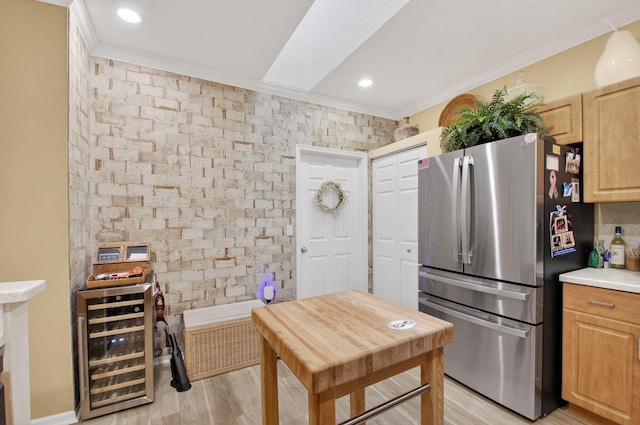 12562 Crystal Pointe Dr Unit B, Boynton Beach, FL 33437 - kitchen featuring freestanding refrigerator, beverage cooler, crown molding, light wood finished floors, and light countertops