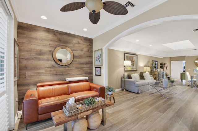 12562 Crystal Pointe Dr Unit B, Boynton Beach, FL 33437 - living room featuring arched walkways, ceiling fan, baseboards, a skylight, and ornamental molding