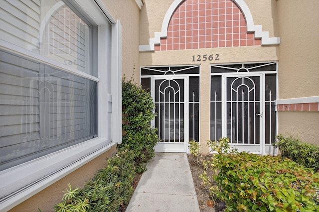 12562 Crystal Pointe Dr Unit B, Boynton Beach, FL 33437 - view of exterior entry featuring stucco siding